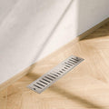 Removable slotted grate cover on 304 stainless steel linear shower floor drain, brushed finish