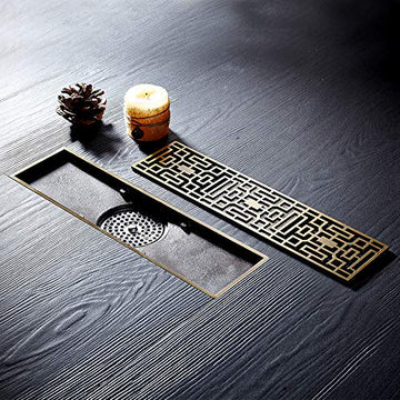 InArt brass 12 inch linear shower drain with antique brass decorative rectangular grate, top view