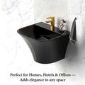 Modern wall mounted bathroom sink in glossy black ceramic with gold accent, centered drain opening, close-up