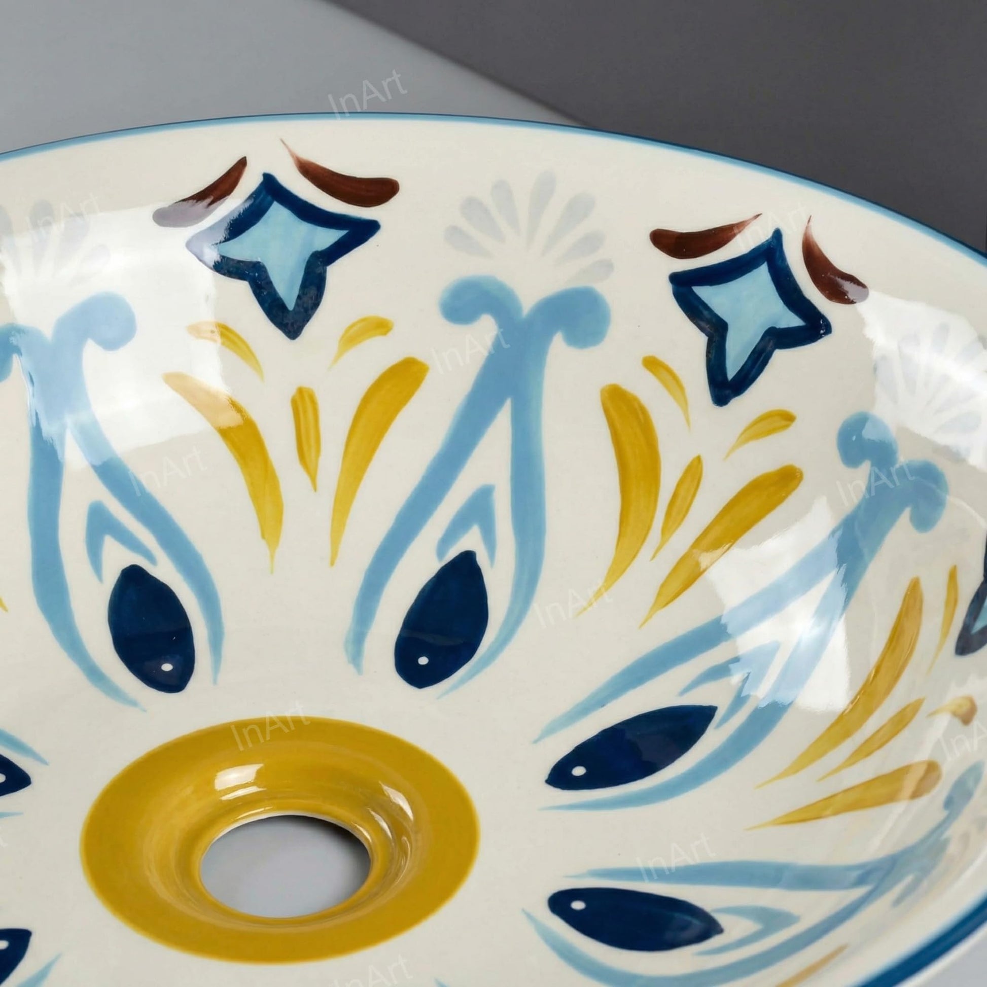 Bowl sinks for the bathroom close-up, glossy ceramic round wash basin with hand-painted blue pattern