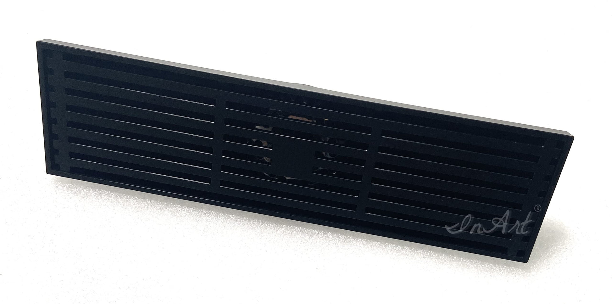 Angled view of brass linear shower drain body with removable matte black grate and center outlet