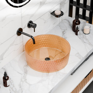 Round amber glass vessel sink with textured faceted exterior, above-counter bathroom bowl