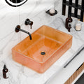 Rectangular tempered glass vessel sink in amber/orange with textured geometric pattern, above-counter bathroom basin