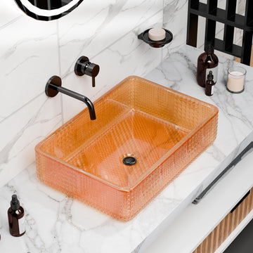 Rectangular tempered glass vessel sink in amber/orange with textured geometric pattern, above-counter bathroom basin