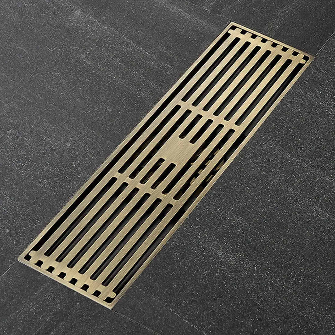 Antique brass linear shower drain with slotted grate cover, brass body, 12-inch class