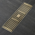 Antique brass linear shower drain with slotted grate cover, brass body, 12-inch class