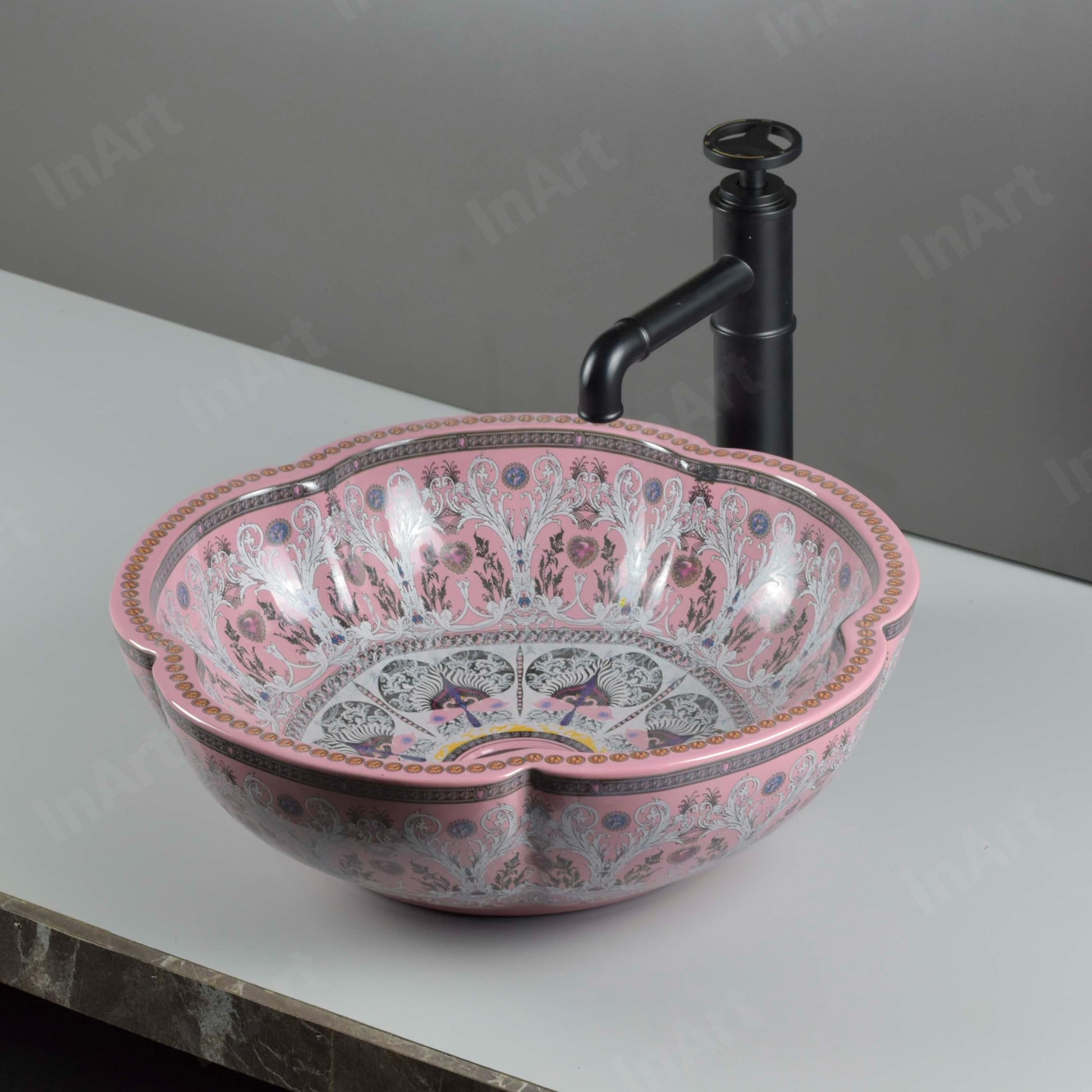 Glazed ceramic round vessel sink with scalloped rim, glossy pink ornate pattern, above-counter basin