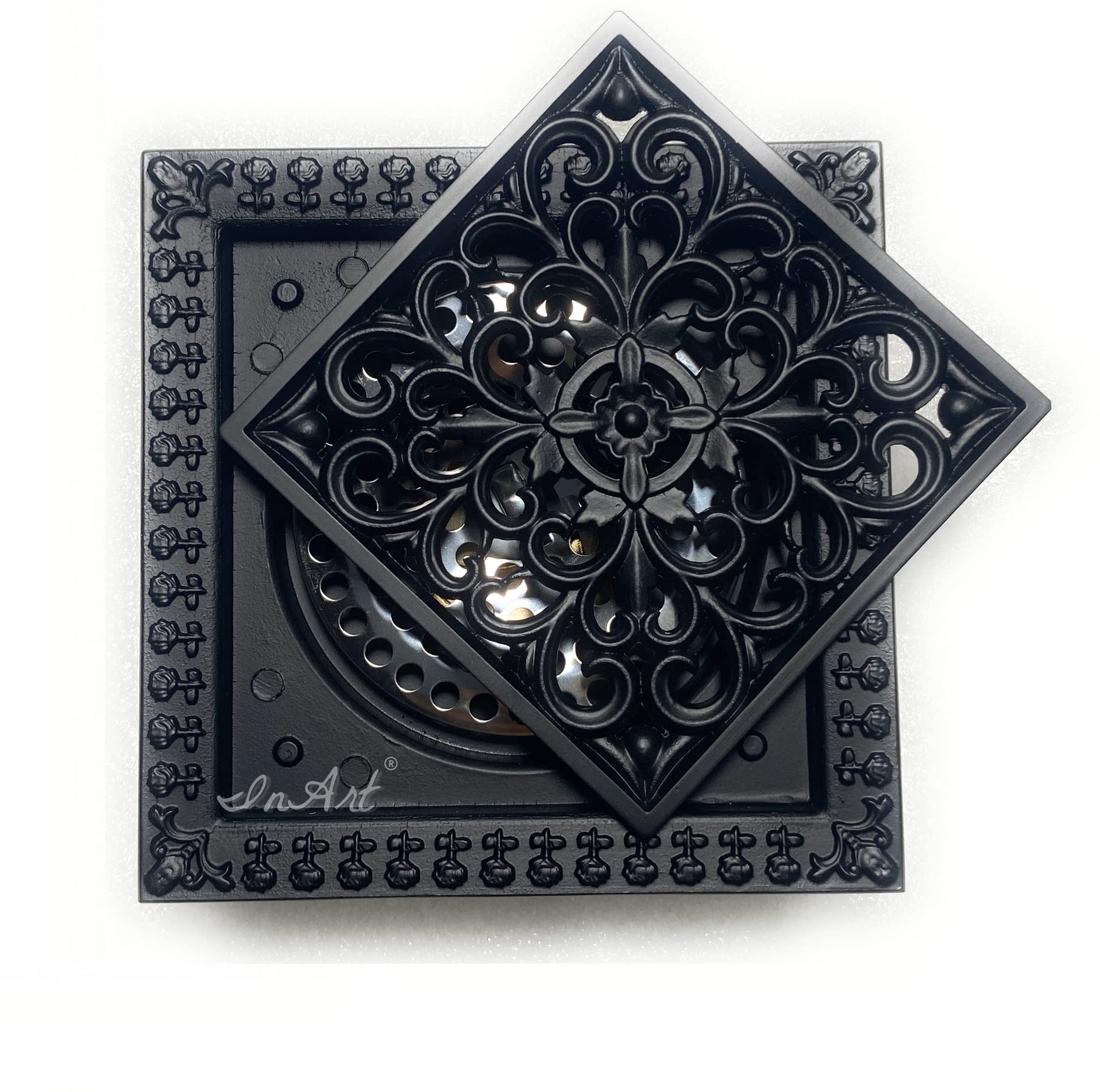 Top view of matte black brass square floor drain cover showing decorative scrollwork grate