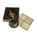 InArt brass square shower drain cover installed flush in tile bathroom floor installation view