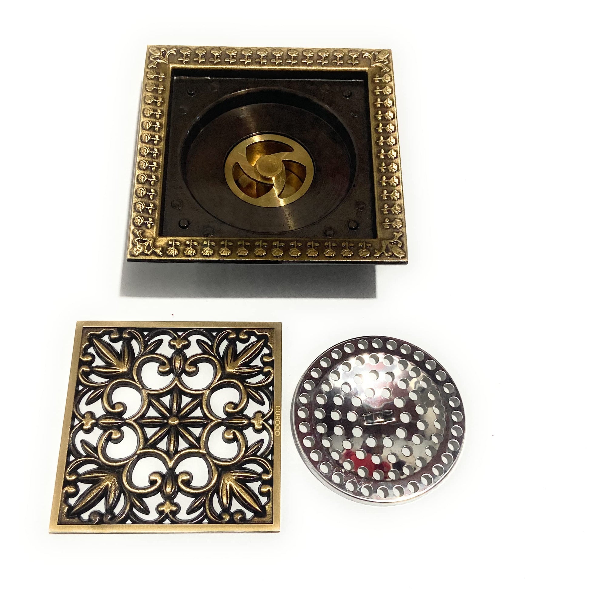 Antique brass square floor drain cover installed flush in tile shower floor, premium brass material