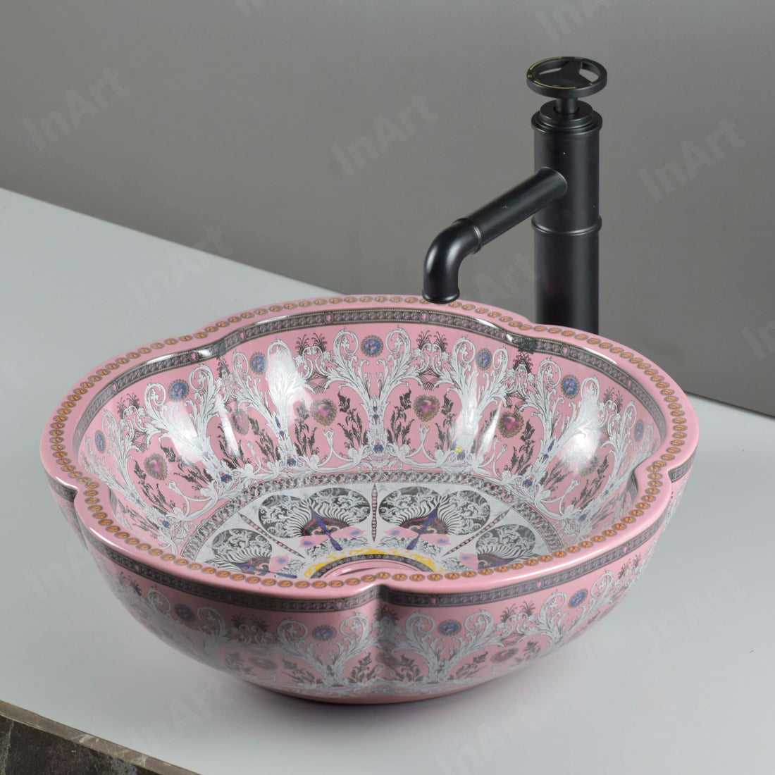 Glazed ceramic round vessel sink with scalloped rim, glossy pink ornate pattern, above-counter basin