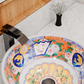Interior view of round ceramic bathroom vessel sink with center drain opening and glossy non-porous glaze